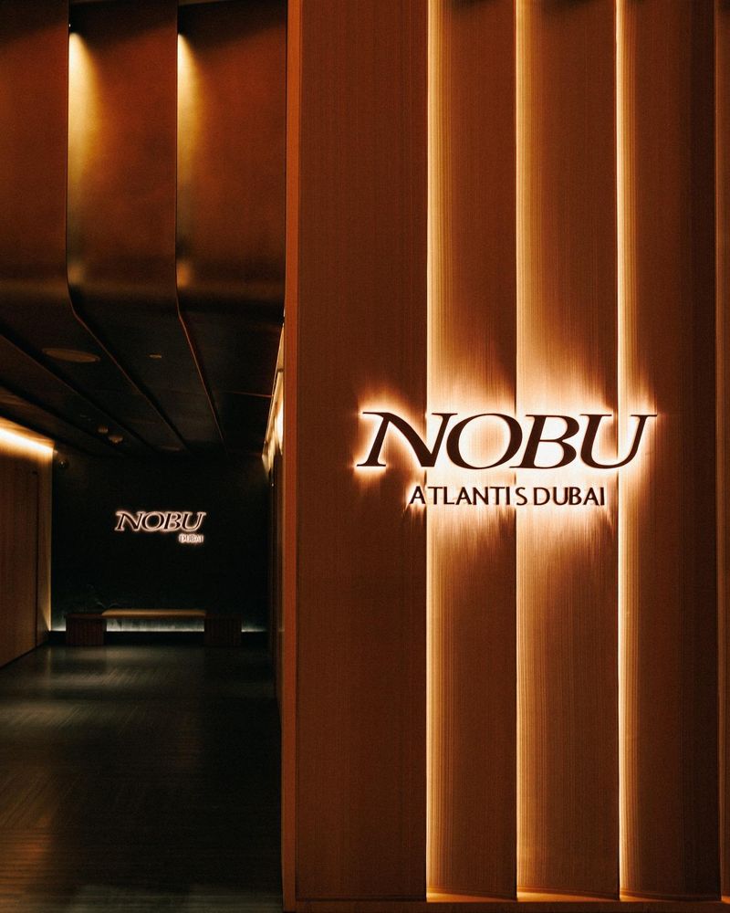 Nobu restaurant entrance with backlit timber walls